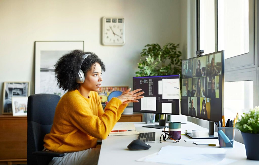 a lady on a video call working frim home. This image illustrates webcams for video calls that perform well in home lighting