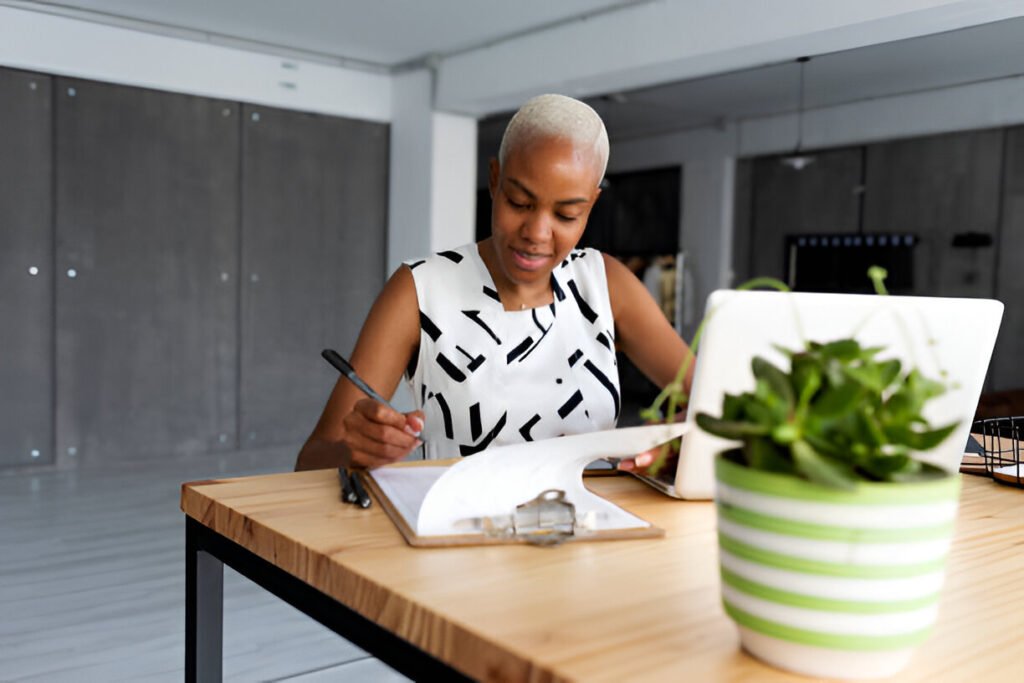 Businesswoman working in modern office, using laptop working on her home office setup checklist
